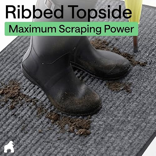 Gorilla Grip Traffic Guard mat's ribbed topside scraping mud off a pair of boots