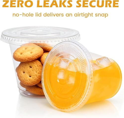 Lamosi 9 oz clear cup with a flat lid holding cookies beside an orange-juice-filled cup, illustrating the no-hole seal