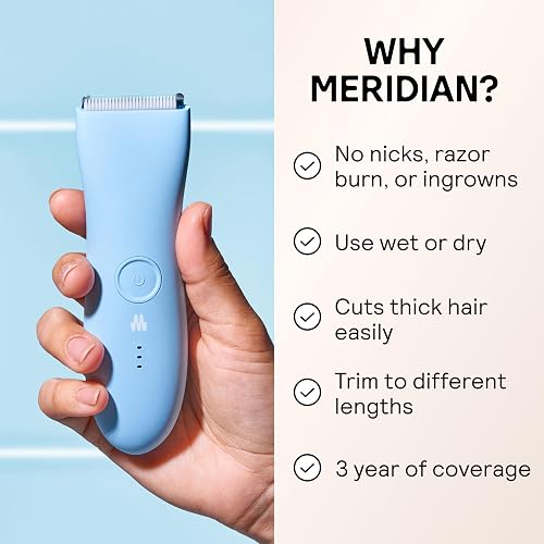 Meridian The Trimmer Original in Sky blue held in hand, showing the power button and battery indicator
