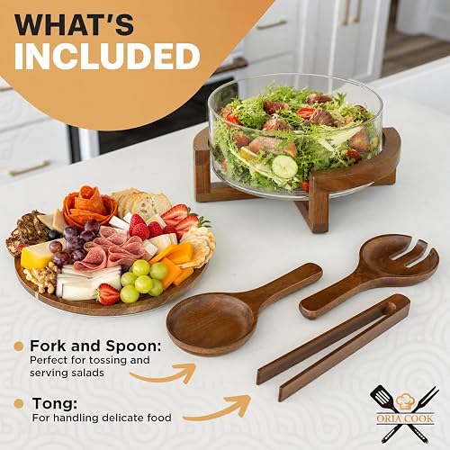 The Oria Cook set laid out on a counter with the glass bowl on its acacia base, the acacia lid used as a charcuterie plate, and the fork, spoon, and tong