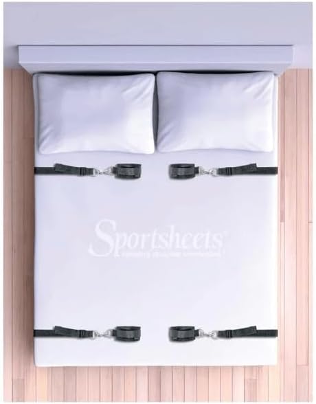 The Sportsheets under-the-bed nylon straps laid across a bed frame before the mattress goes back down